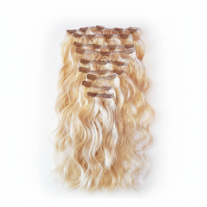 Blonde clip-in hair extensions on white background